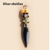 A silver obsidian crystal ball decorative piece featuring gold and green accents.