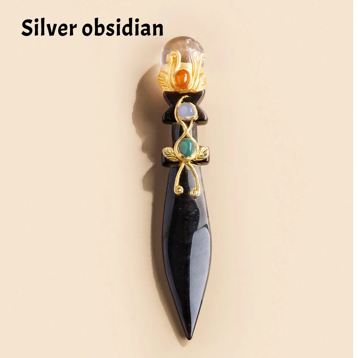 A silver obsidian crystal ball decorative piece featuring gold and green accents.