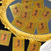 A close-up of gold-colored wealth amulets or stickers displayed in a ornate gold frame.