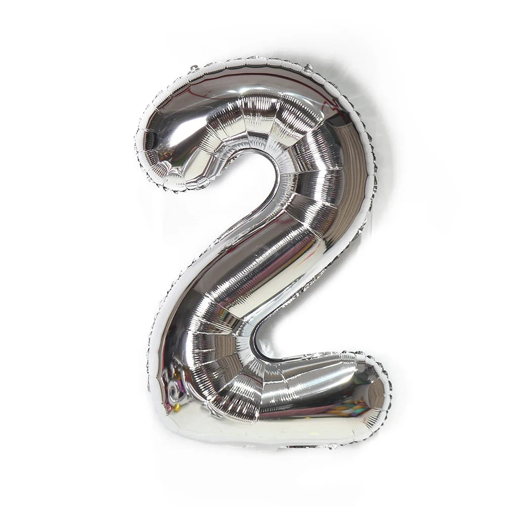 A metallic silver foil balloon shaped like the number 2.