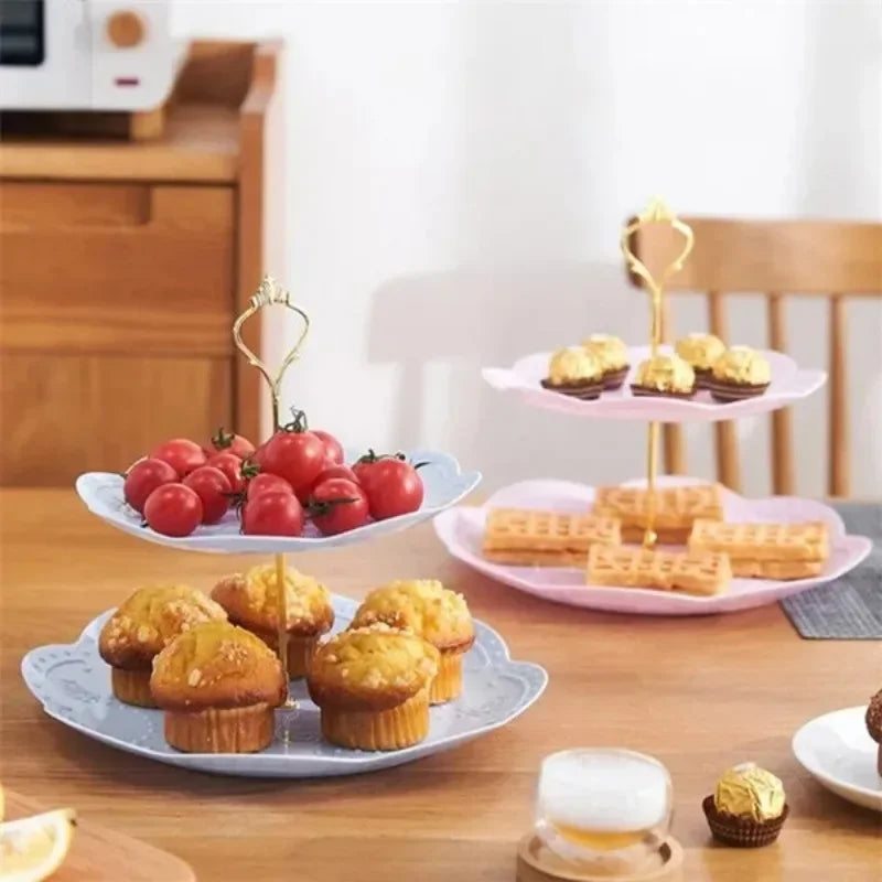 A 3-tier detachable cake stand for desserts and fruit featuring pink and gold accents on a wooden table.