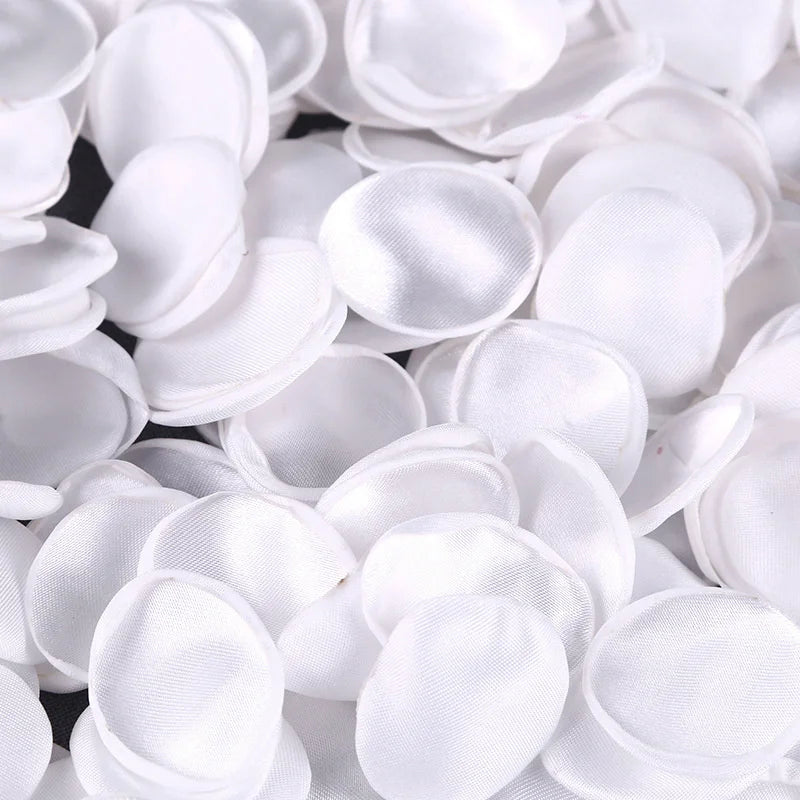 A close-up view of white silk rose petals for weddings and events.