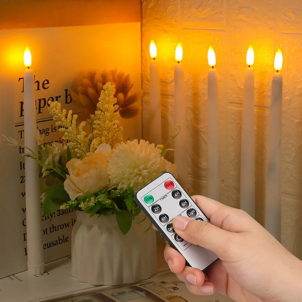 A hand holds a remote control for flameless LED taper candles with a timer and light, displayed next to lit candles.