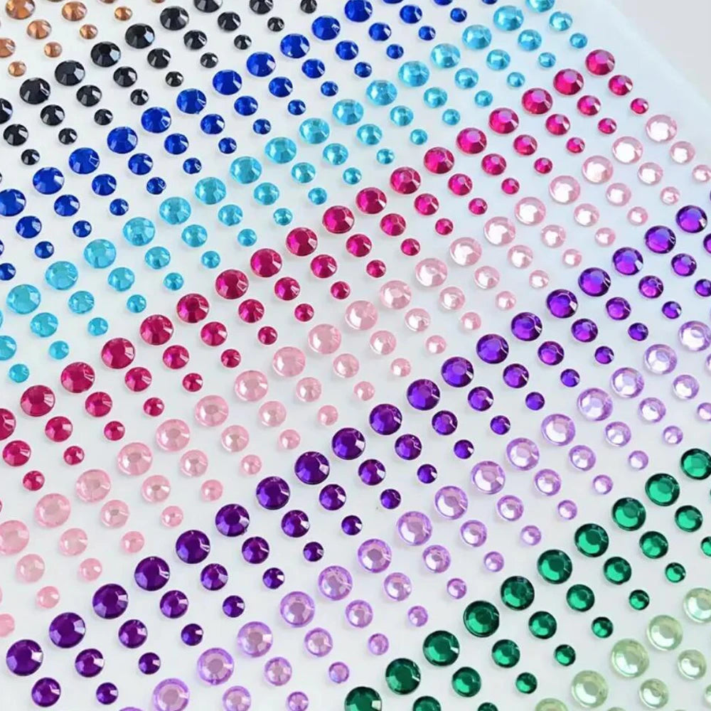 A close-up view of a grid of colorful glitter gems in various shades including pink, blue, purple, and green.