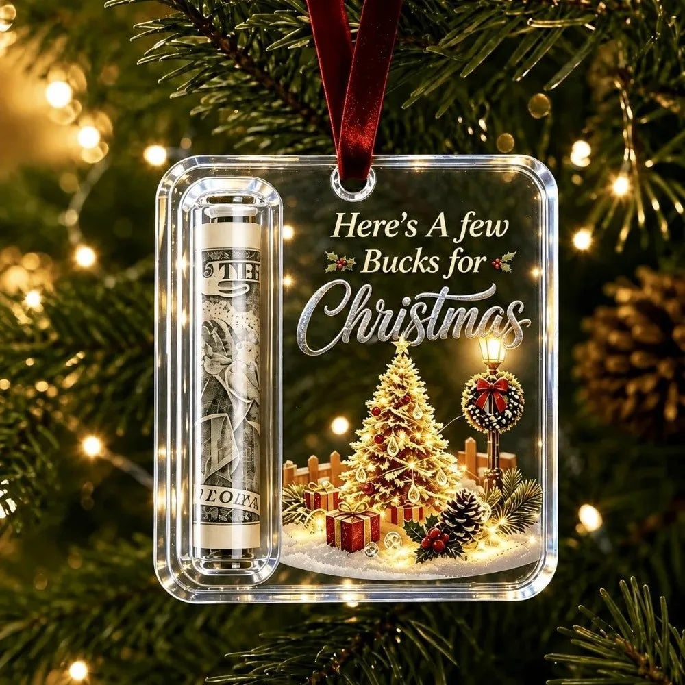 Clear acrylic ornament featuring a Christmas tree, gifts, and a bottle of liquor, suspended by a red velvet ribbon.