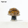 A natural crystal mushroom tree sculpture with a golden-brown top and dark base.