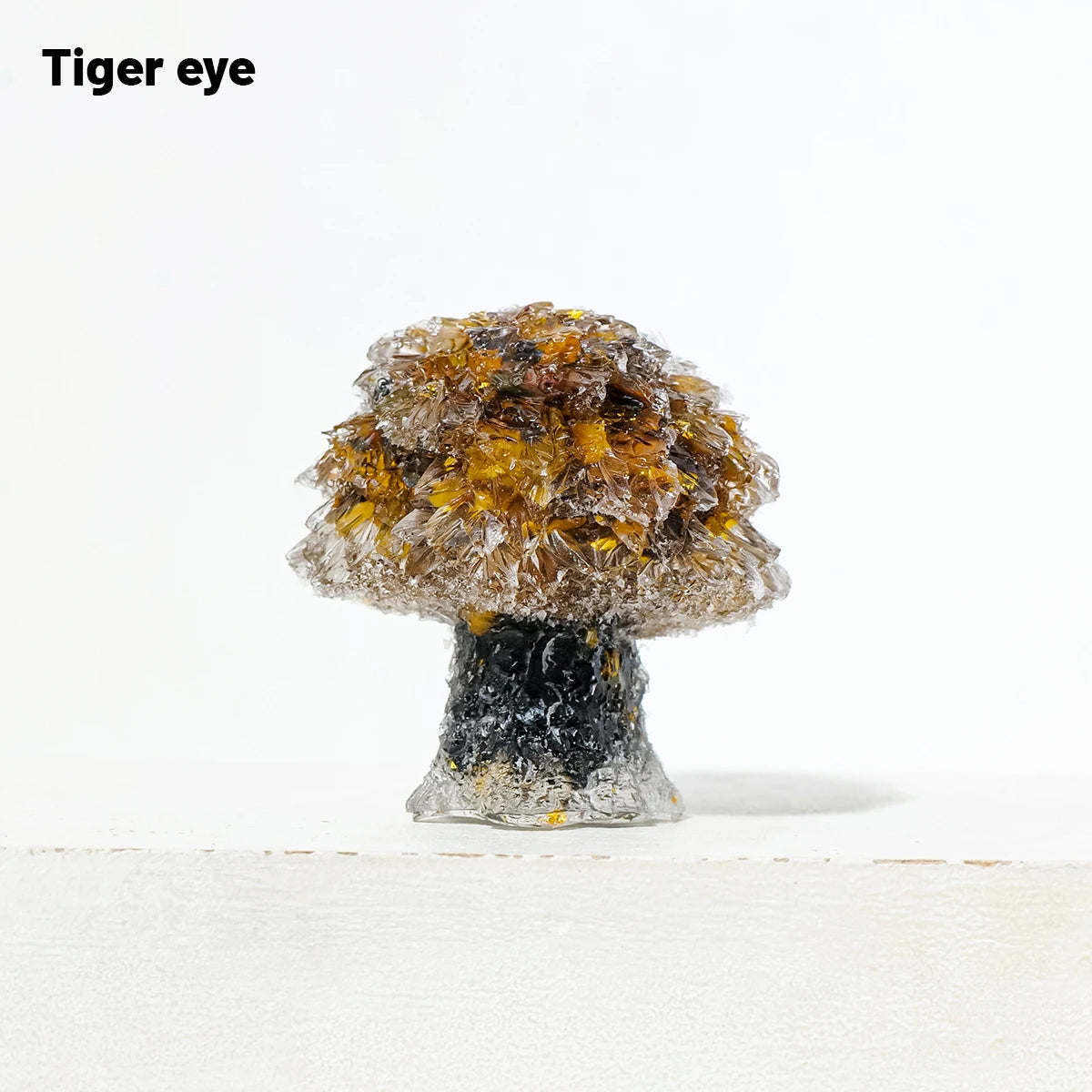 A natural crystal mushroom tree sculpture with a golden-brown top and dark base.