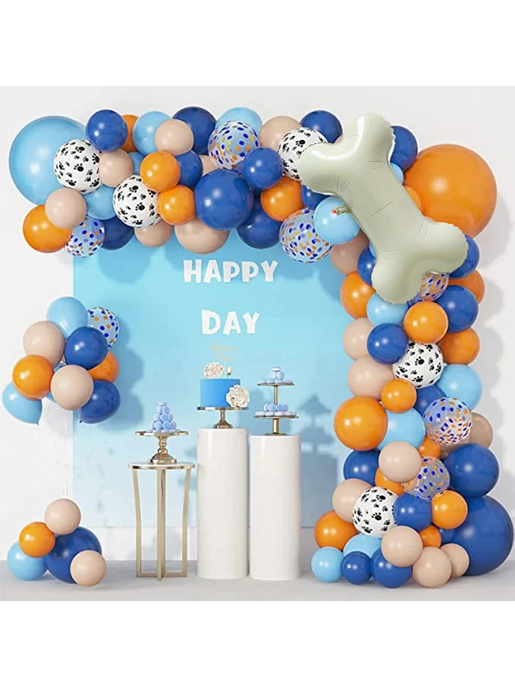 A balloon garland featuring various colors and shapes, including a large bone-shaped balloon, for a birthday party decoration