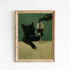 Canvas art print featuring a black cat pouring red wine into a glass, framed in wood.