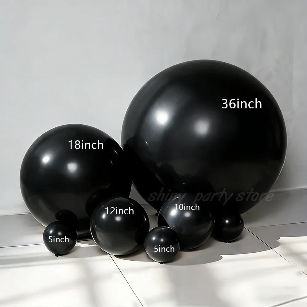A collection of black latex balloons of various sizes, including 5 inch, 10 inch, 12 inch, 18 inch, and 36 inch.