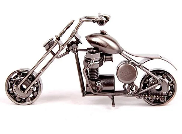 A handcrafted metal motorcycle model with chrome detailing displayed against a white background.