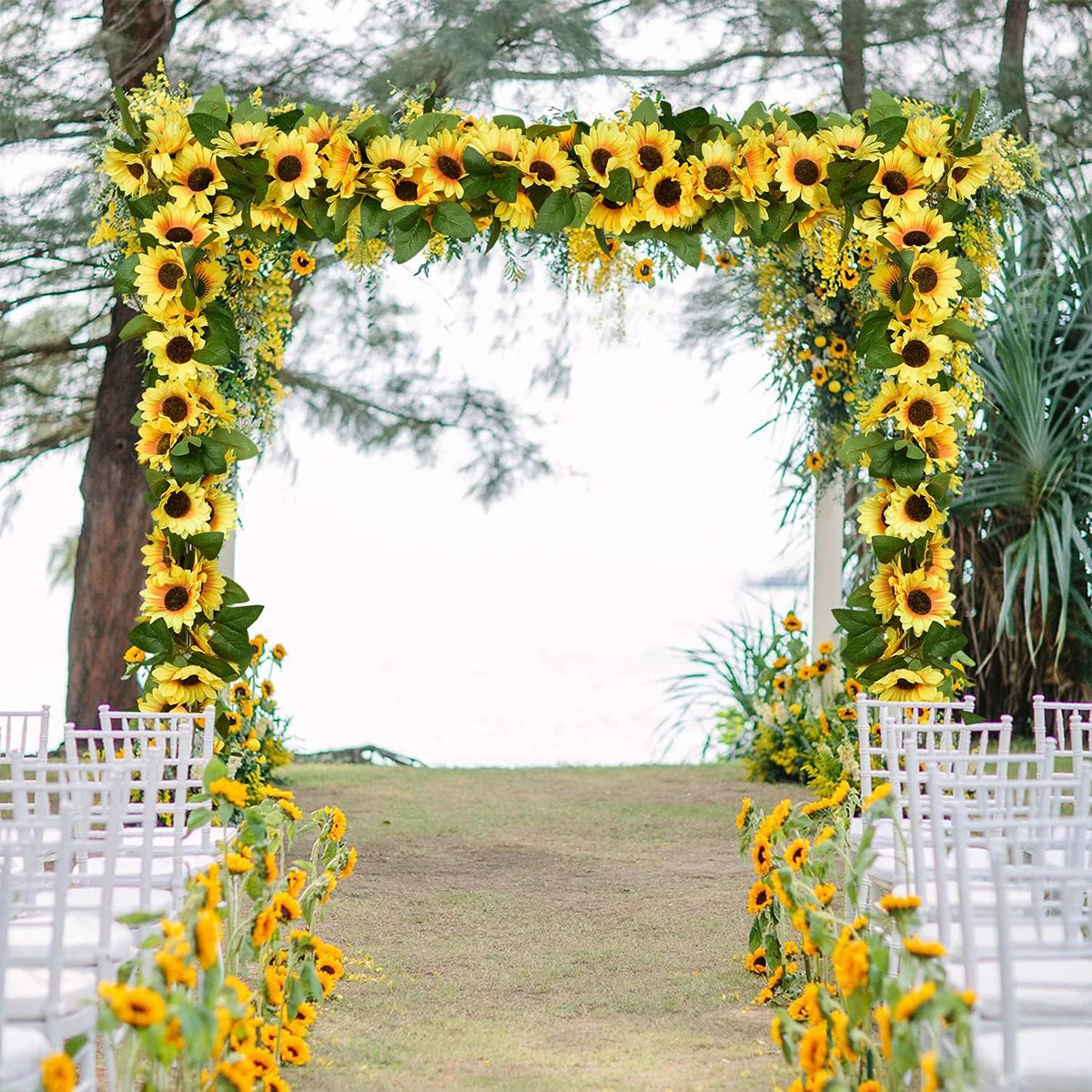 A floral archway decorated with yellow sunflowers and greenery for a wedding ceremony backdrop.