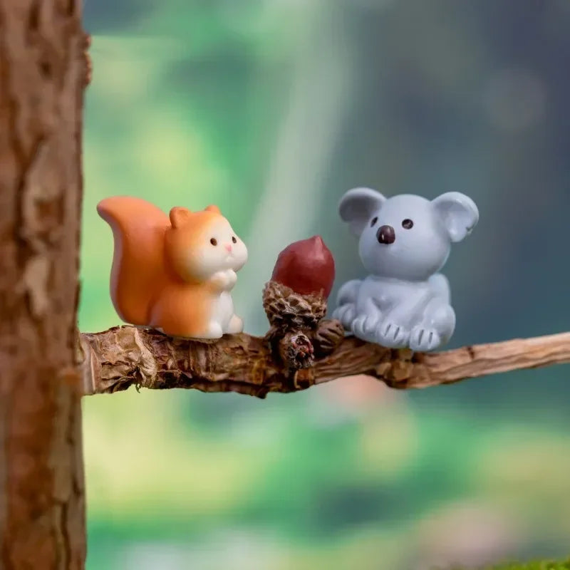 A set of three small ceramic animal figurines, including an orange fox, a reddish-brown nut, and a gray bear, displayed on a 