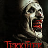 A close-up, dark portrait of a menacing clown face with blood and scars, featuring the title Terrifier.