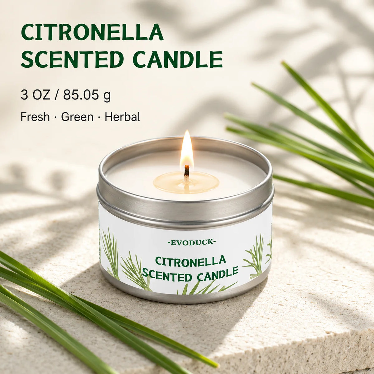 A jar of citronella scented candle with a lit wick set against a background of green leaves.