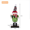 A festive wooden nutcracker soldier ornament with a red and green striped hat and green body.
