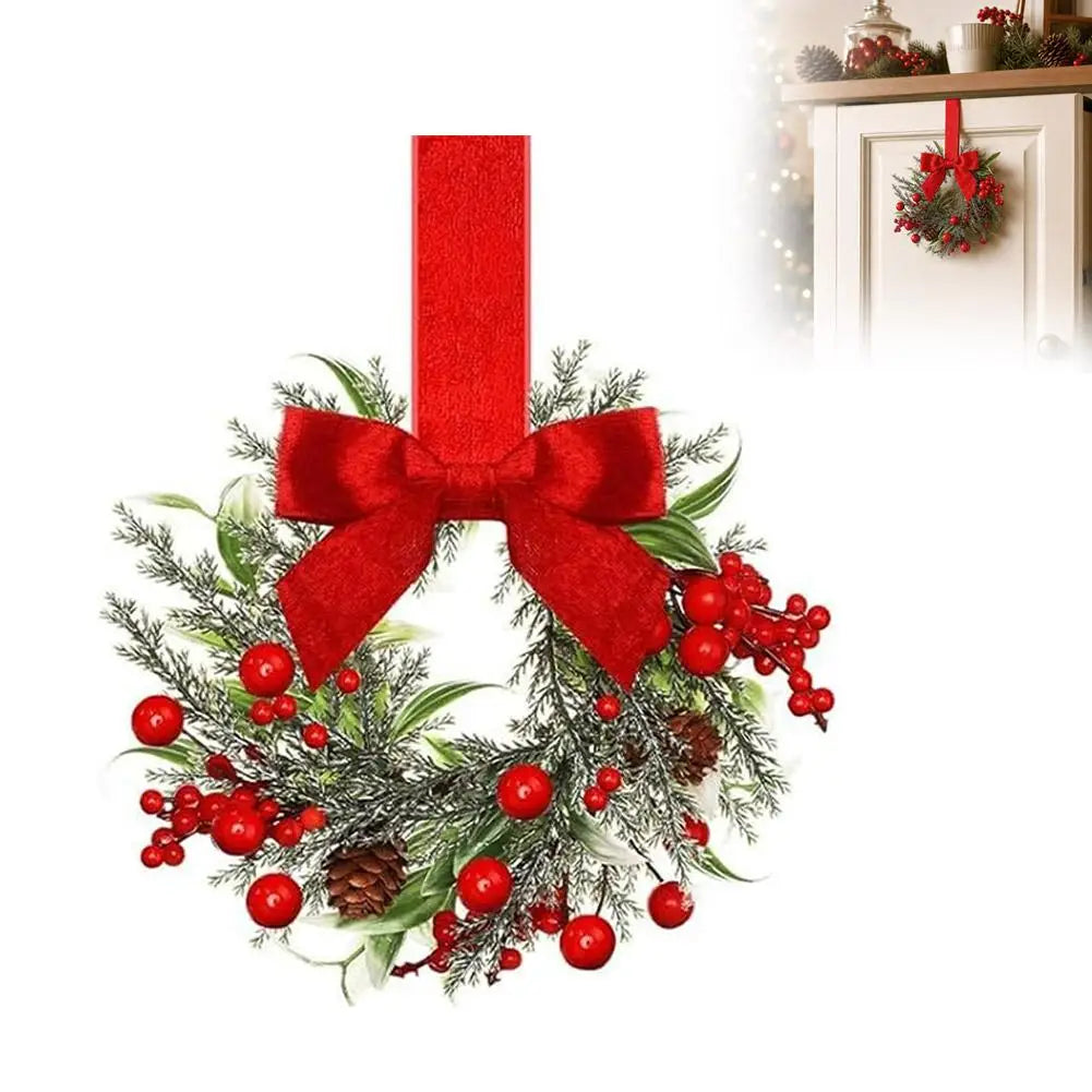 A 10-inch artificial Christmas wreath decorated with green foliage, red berries, and a large red velvet bow.