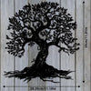 Black silhouette of a large tree with roots on a light wooden background.