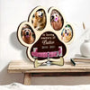 A wooden paw-shaped photo frame featuring portraits of a dog, dedicated in loving memory of Butter 2010-2021.