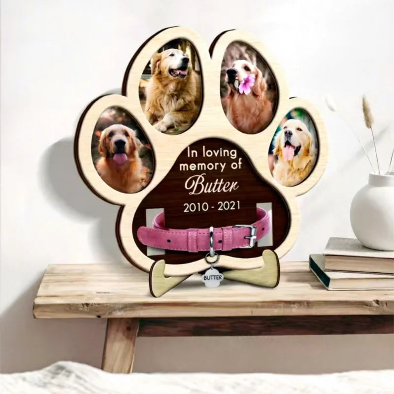A wooden paw-shaped photo frame featuring portraits of a dog, dedicated in loving memory of Butter 2010-2021.