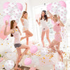 Five young women posing with pink and white latex balloons in a bright, airy room.