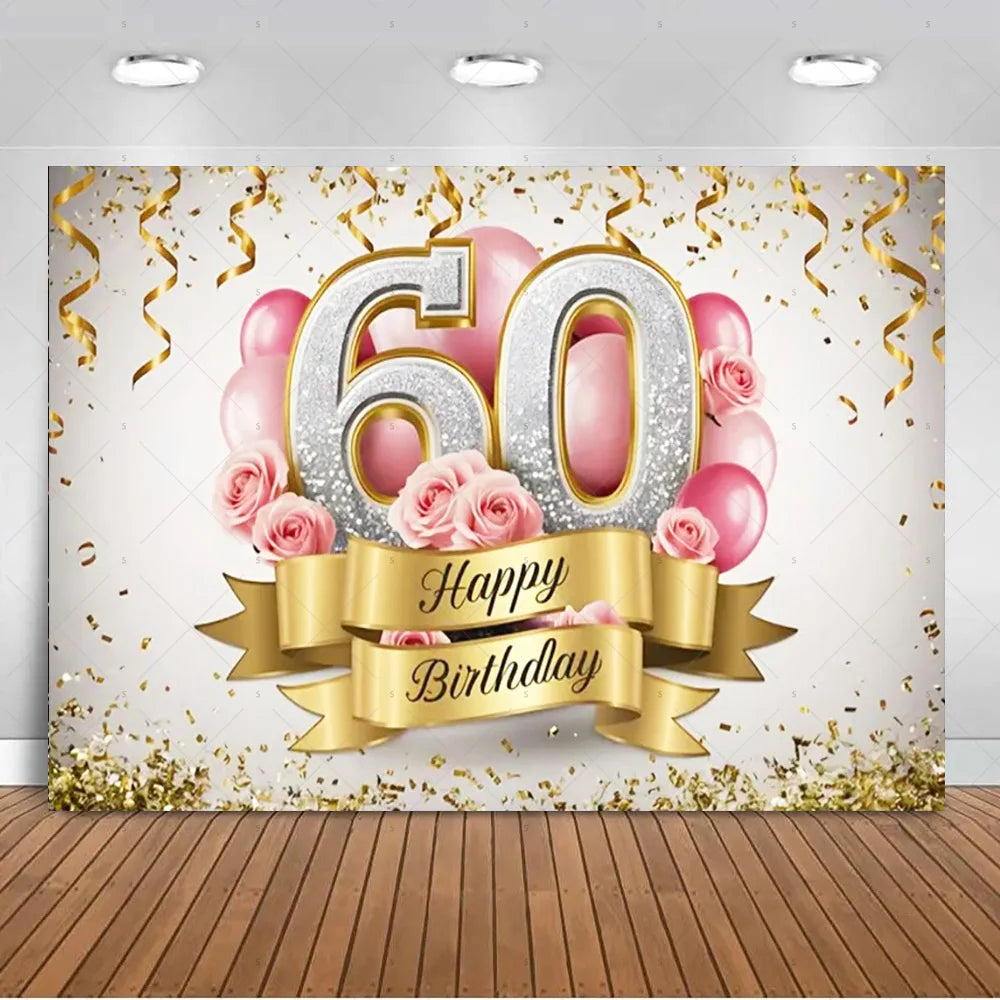 A photo booth backdrop featuring large gold and silver balloons spelling 60 and pink roses with gold streamers.
