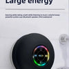 A black bathroom suction cup speaker is mounted on a white tile wall.