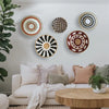 Bohemian straw wall decor featuring circular woven patterns in natural and earthy tones.