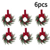 Six artificial Christmas wreaths with red berries and velvet bows