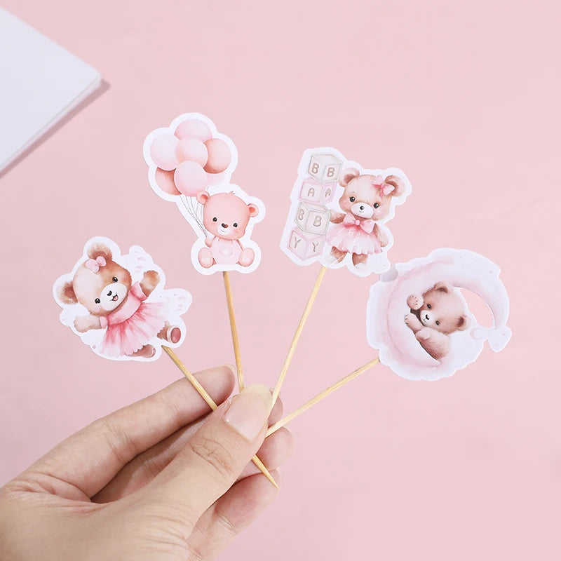 Pink paper cupcake toppers featuring cute cartoon bears for baby shower and birthday parties