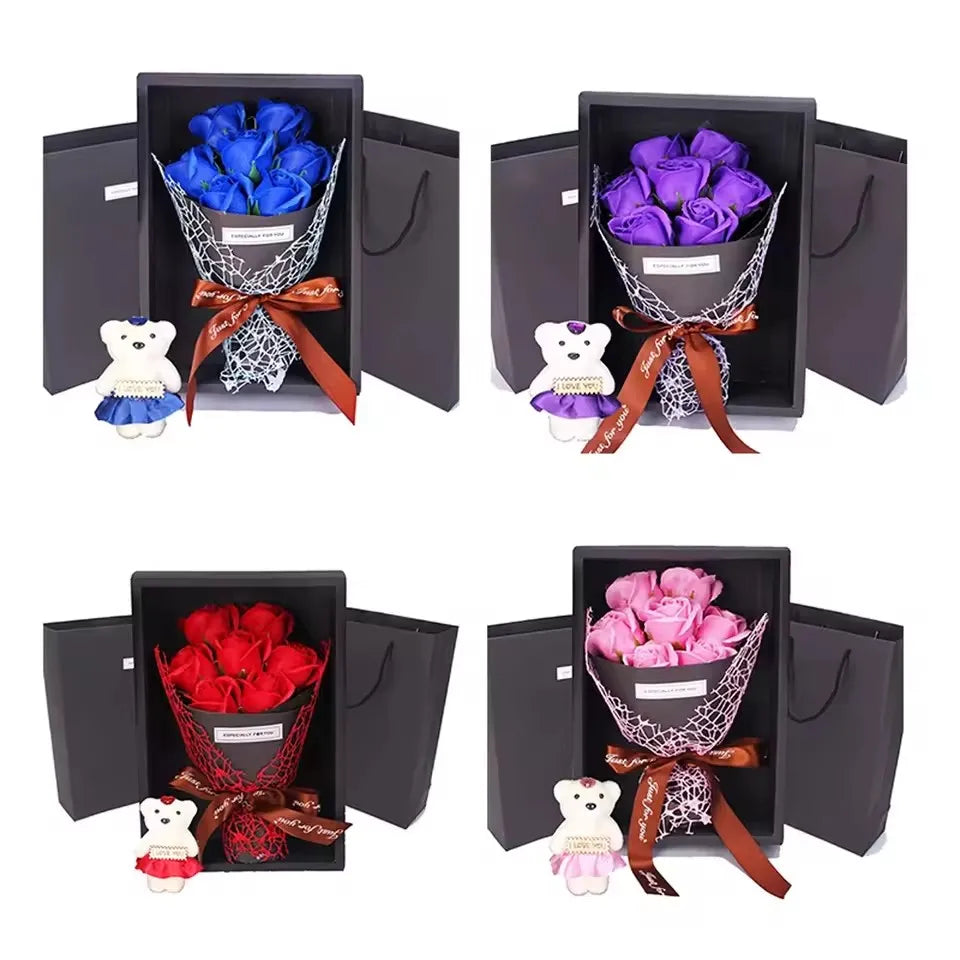 A gift box containing a rose bouquet and a plush bear, tied with an orange ribbon.