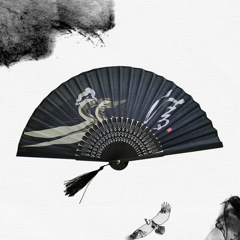 A black vintage bamboo folding hand fan with a decorative pattern and a plume, set against a white background.