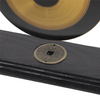 A brass Feng Shui gong decor set featuring a circular gong mounted on a black wooden plaque.