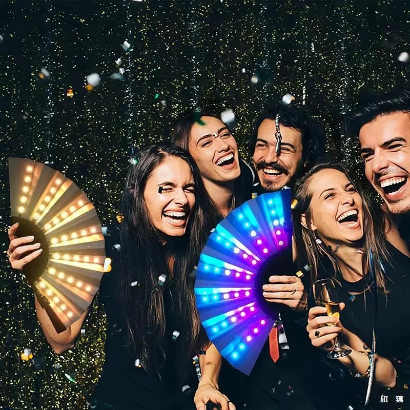 Five young adults smiling while holding a glowing LED fan for parties and events