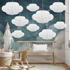 A white honeycomb ball decoration set is displayed in a room with a wooden bench and soft lighting.