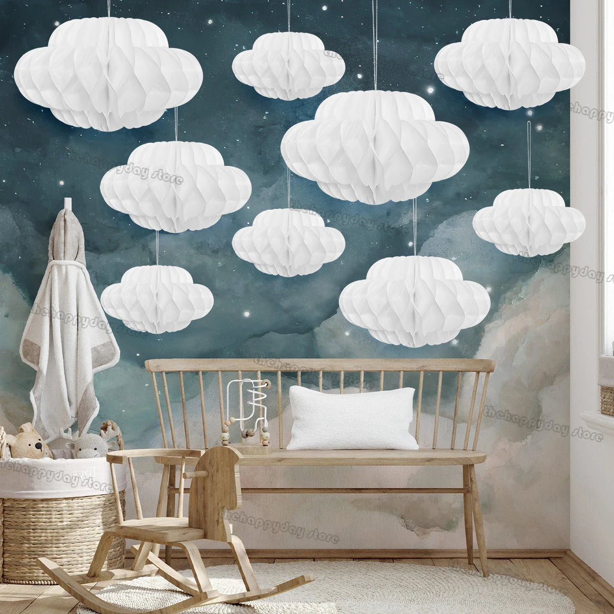 A white honeycomb ball decoration set is displayed in a room with a wooden bench and soft lighting.
