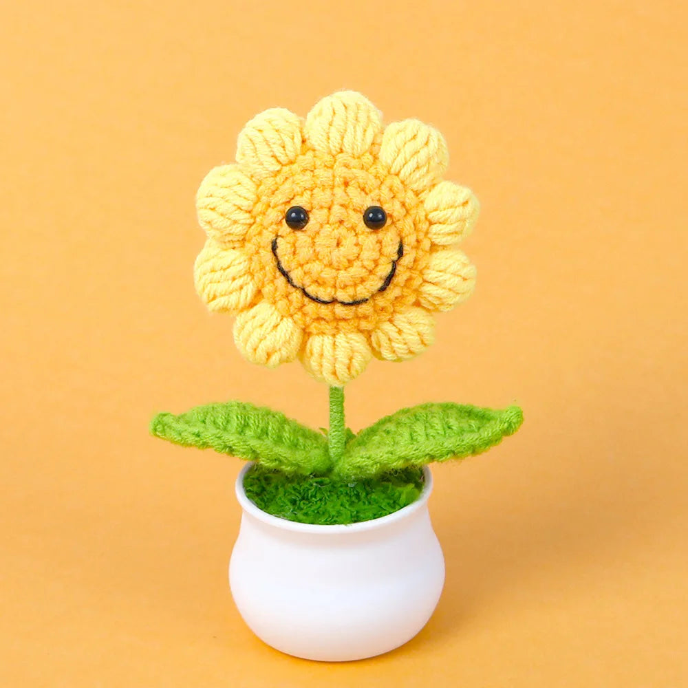 Hand woven crochet yellow sunflower plant in a white pot