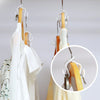 A close-up view of wooden hanger connectors and white hangers hanging on a rack.