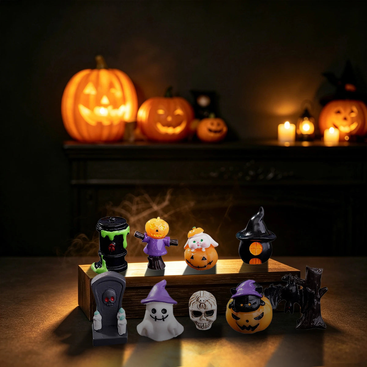 A collection of spooky resin figurines, including jack-o'-lanterns and witches, displayed on a wooden surface.