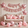 Pink marble birthday balloon decoration set featuring a banner and balloons on a light pink rug.