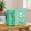 Two teal green photo albums with cartoon designs featuring a bird and a cloud