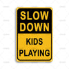A yellow rectangular sign with black text that reads SLOW DOWN KIDS PLAYING