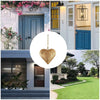 Antique golden metal heart wall decor hanging on a door