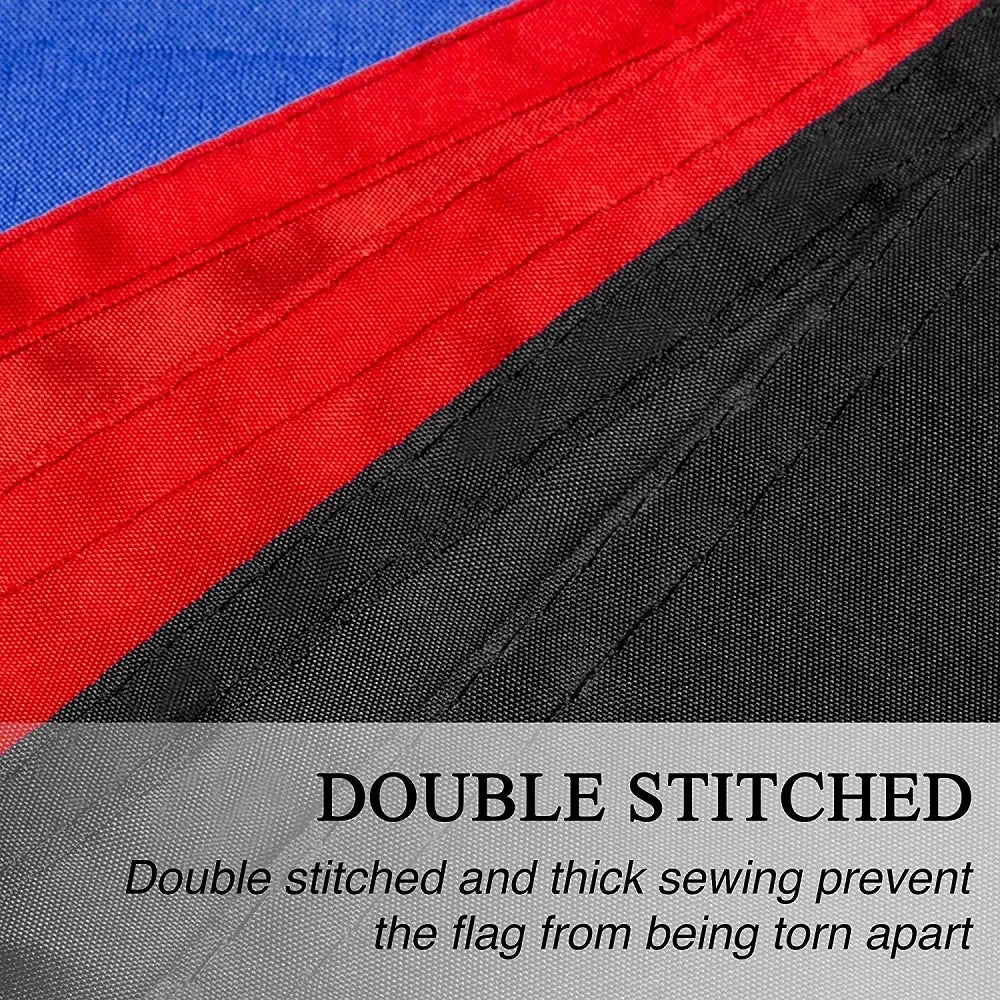 Close-up of a red, white, and green flag tapestry showing double stitched black fabric detail.