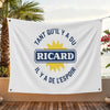 A white flag featuring blue text and a yellow sun graphic with the name RICARD and surrounding French phrases.