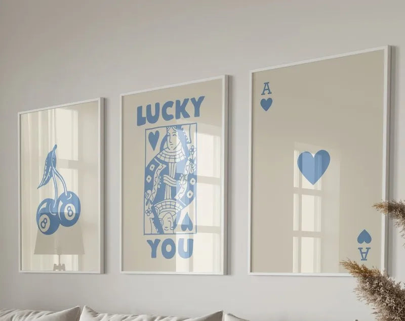 Three framed art prints featuring lucky hearts and the text I love you on a light gray wall.