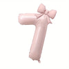 A large pink foil number balloon shaped like the number one with a bow.