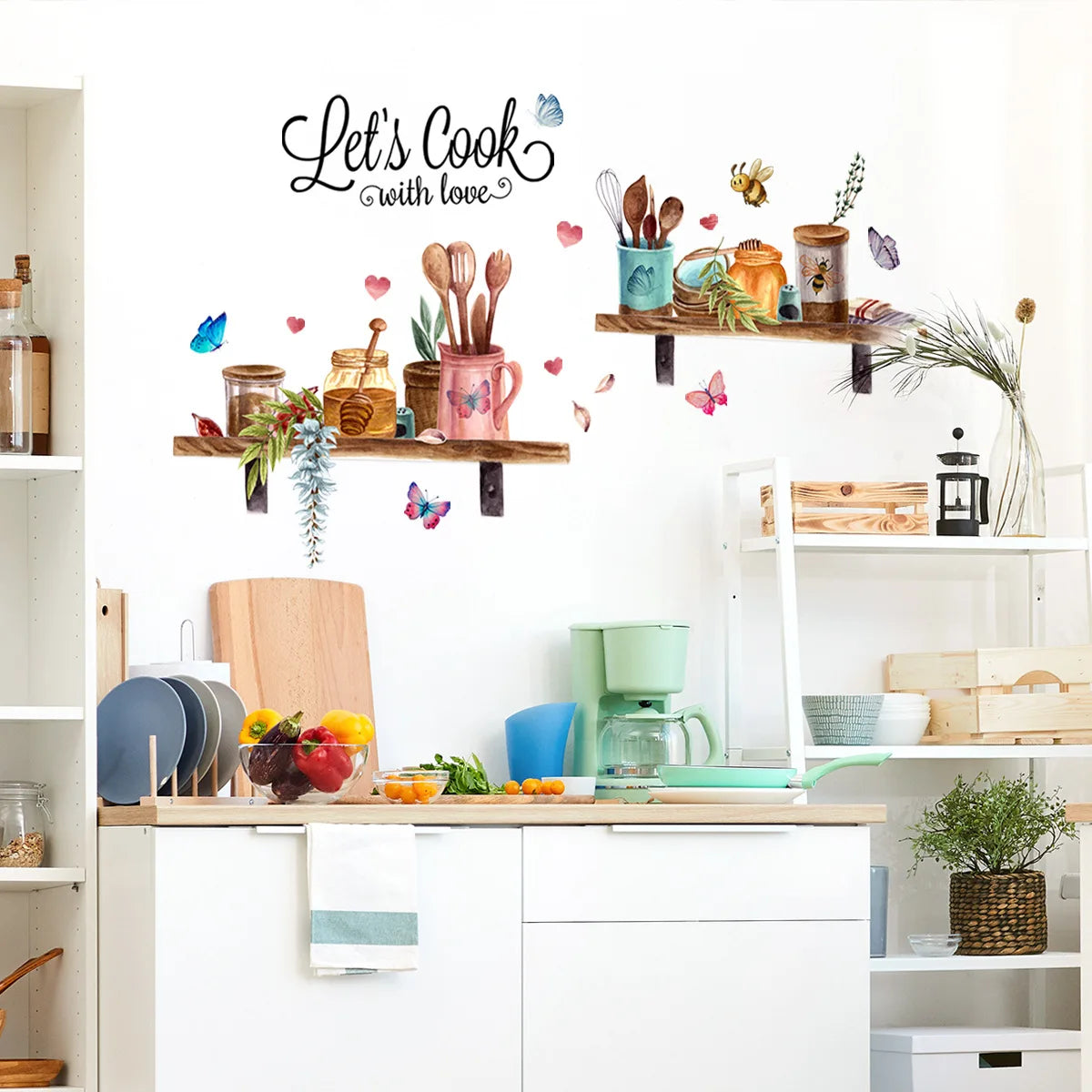 A wall sticker featuring a 'Let's Cook with love' design with various cooking utensils and floral elements on a wooden shelf.