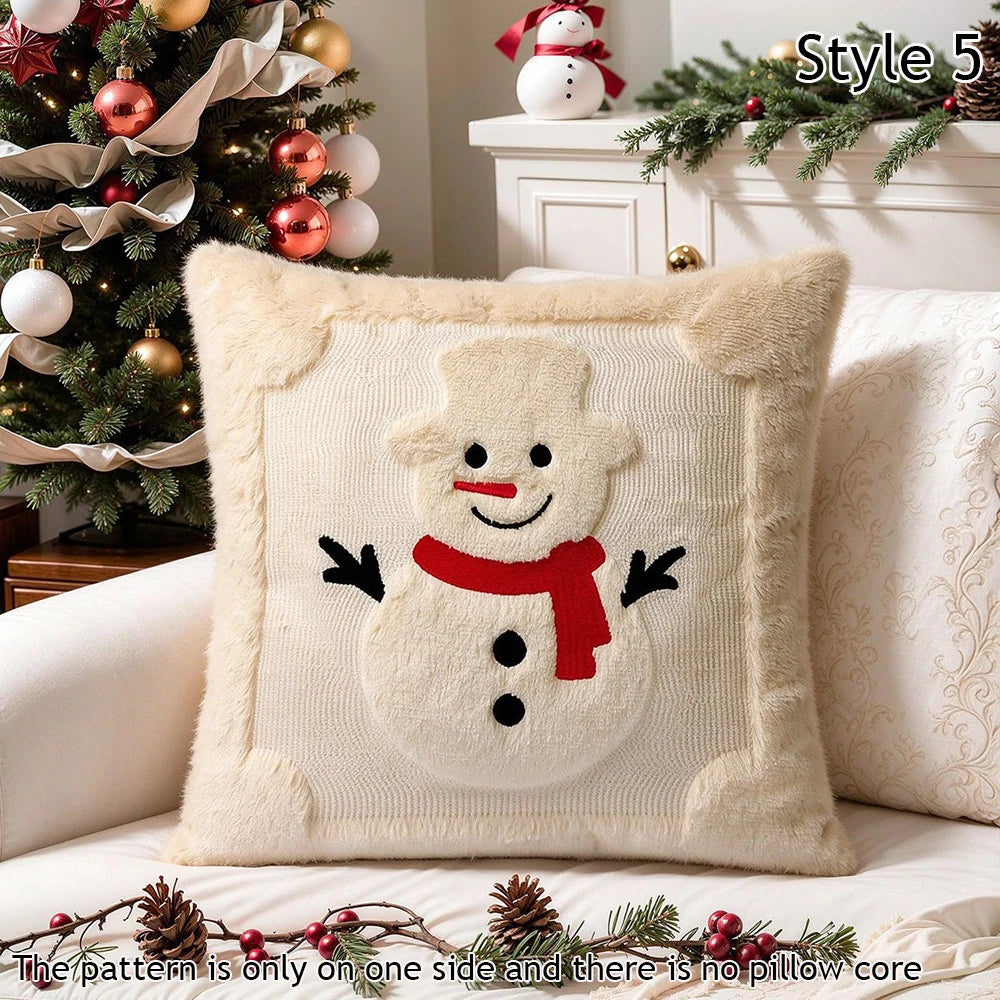 A cream-colored embroidered pillow featuring a festive snowman design with a red scarf and black buttons.