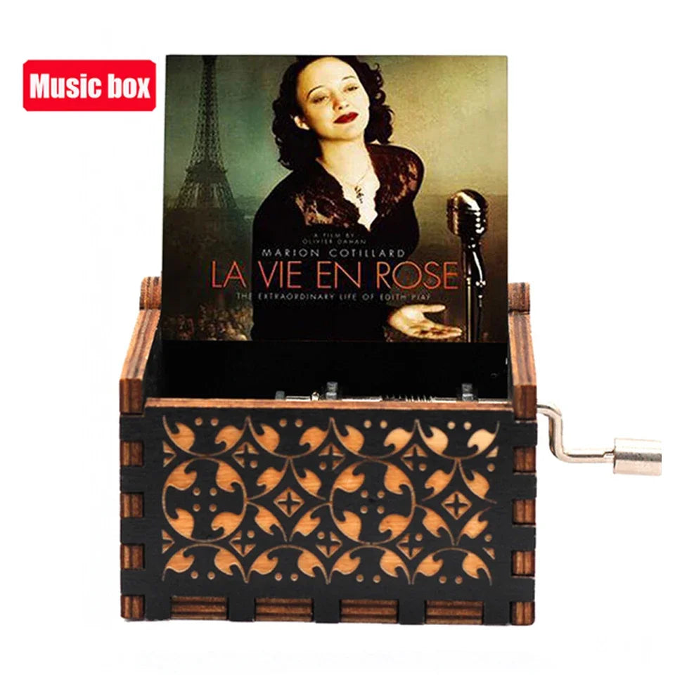 A carved wooden music box featuring a photograph of Marion Cotillard in a dark setting.